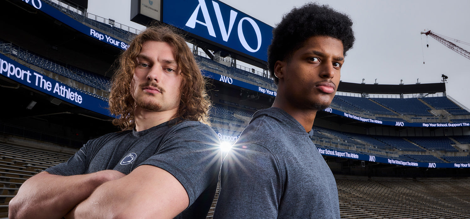 Two Penn State football players posing in the stadium